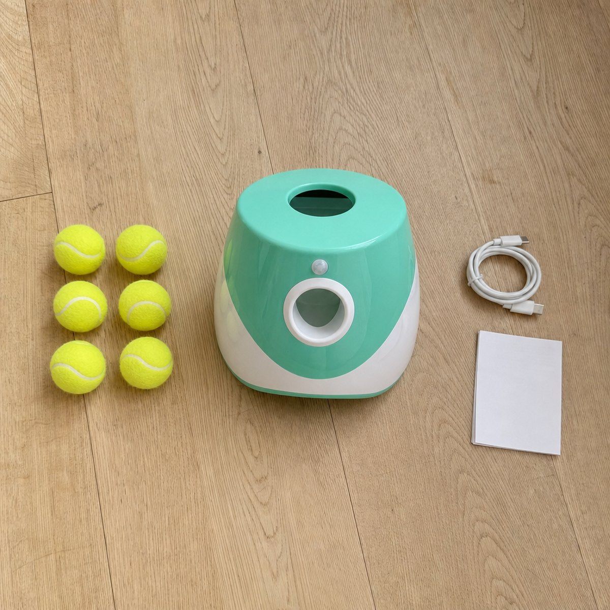 What's in the box: the launcher, 6 mini tennis balls, USB-C cable and manual